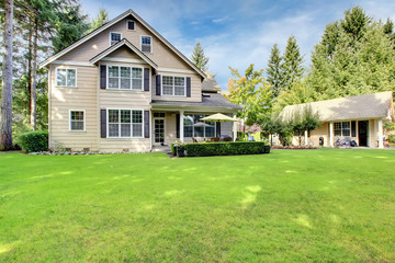 Beige house with large back yard