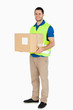 © WavebreakmediaMicro - Smiling young delivery man holding a parcel