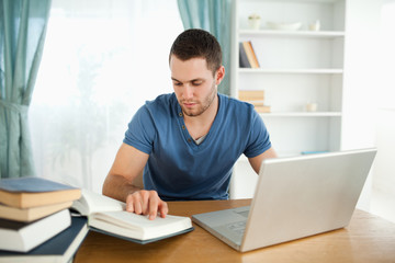 Poster - Student uses his laptop to work through his subject material