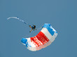 Skydiver hanging on parachute in air