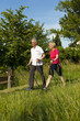 © Kzenon - Happy mature or senior couple doing Nordic walking in summer