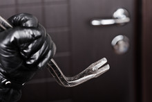Burglar Hand Holding Crowbar Break Opening Door