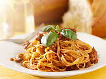 Spaghetti With Basil Garnish In Meat Sauce