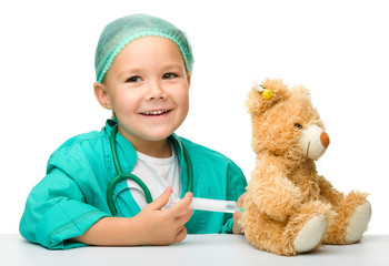 Little girl is playing doctor with syringe