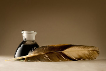 A feather with the bottle full of ink