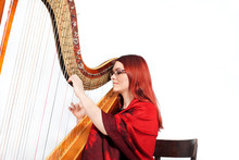 Girl Playing On A Harp