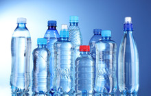 Group Plastic Bottles Of Water On Blue Background