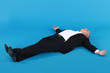 man lying against blue background