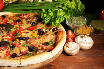 Wall Mural - delicious pizza, vegetables and spices on wooden table