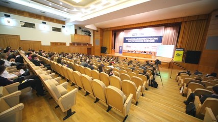 Wall Mural - Many people sit in large hall with wooden chairs at conference