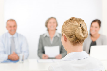 Wall Mural - Job interview young woman with business team