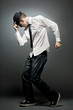 © Mirma - Young man in white shirt and black hat dancing.