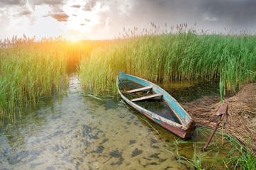 Canvas Print - Boat at coast against a coming nearer thunder-storm.