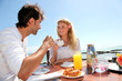 © goodluz - Couple having breakfast by blue lagoon