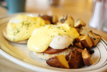 Delicious Eggs Benedict With Seasoned Potatoes For Breakfast.
