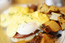 Delicious Eggs Benedict With Seasoned Potatoes For Breakfast.
