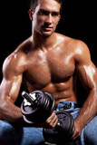 Fitness - powerful muscular man lifting weights