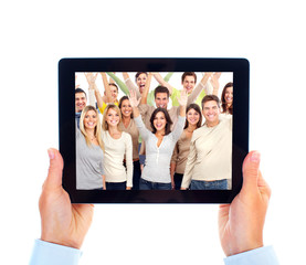 Tablet computer and group of happy people.