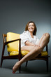 © Mirma - Happy mature woman relaxing on chair.