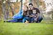 © Andy Dean - Happy Mixed Race Ethnic Family Playing with Bubbles In The Park