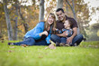 © Andy Dean - Happy Mixed Race Ethnic Family Playing with Bubbles In The Park