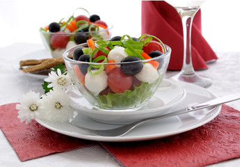 Salad of lettuce, cherry tomatoes, olives and mozzarella with pe