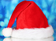 © Africa Studio - Beautiful Christmas hat on a blue background