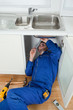 © WavebreakmediaMicro - Portrait of a smiling plumber fixing a sink