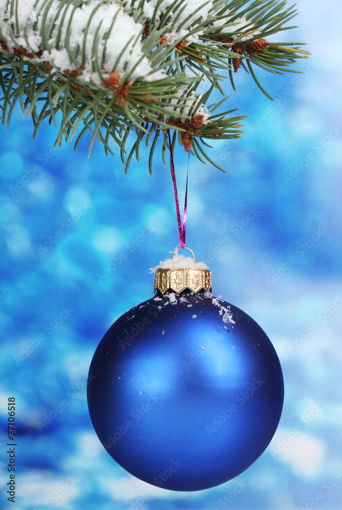 Christmas ball on the tree on blue