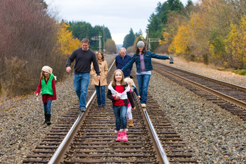 Wall Mural - Group of people walking down the train tracks