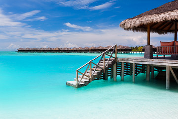 Wall Mural - Over water bungalow with steps into blue lagoon