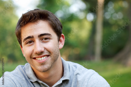 Young man portrait at the park with copy space Poster