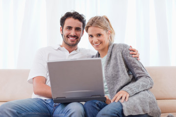 Poster - Young couple using a notebook
