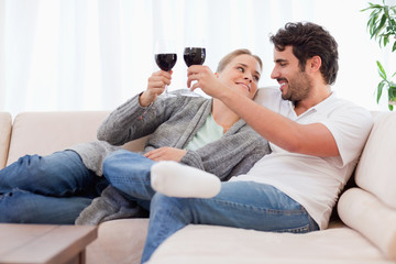 Poster - Young couple having a glass of wine