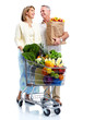 © grinny - Senior couple with a grocery shopping cart.