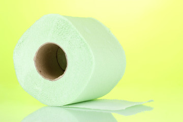 green roll of toilet paper on green background