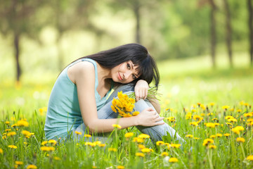 Poster - Cute woman in the park with dandelions