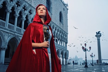 Beautiful woman in red cloak against Dodge's Palace