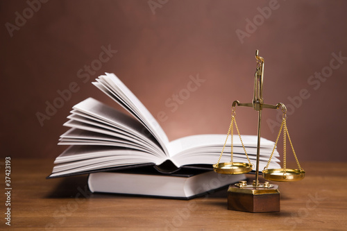 Plakat na zamówienie Scales of justice and gavel on desk with dark background