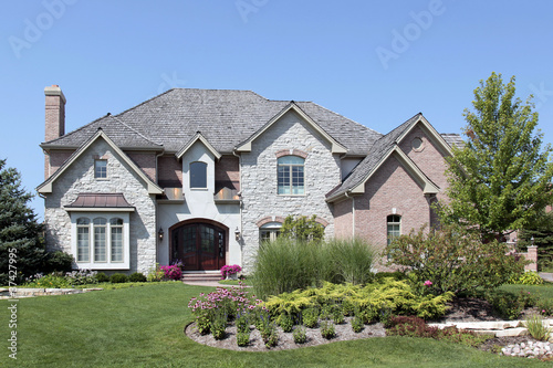 Fotografie, Obraz Stone and brick home with arched doorway