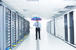 © .shock - businessman hold umbrella in server room