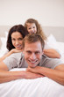 © WavebreakmediaMicro - Cheerful family relaxing on the bed together