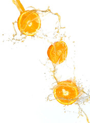 Fresh oranges with juice splash, isolated on white background