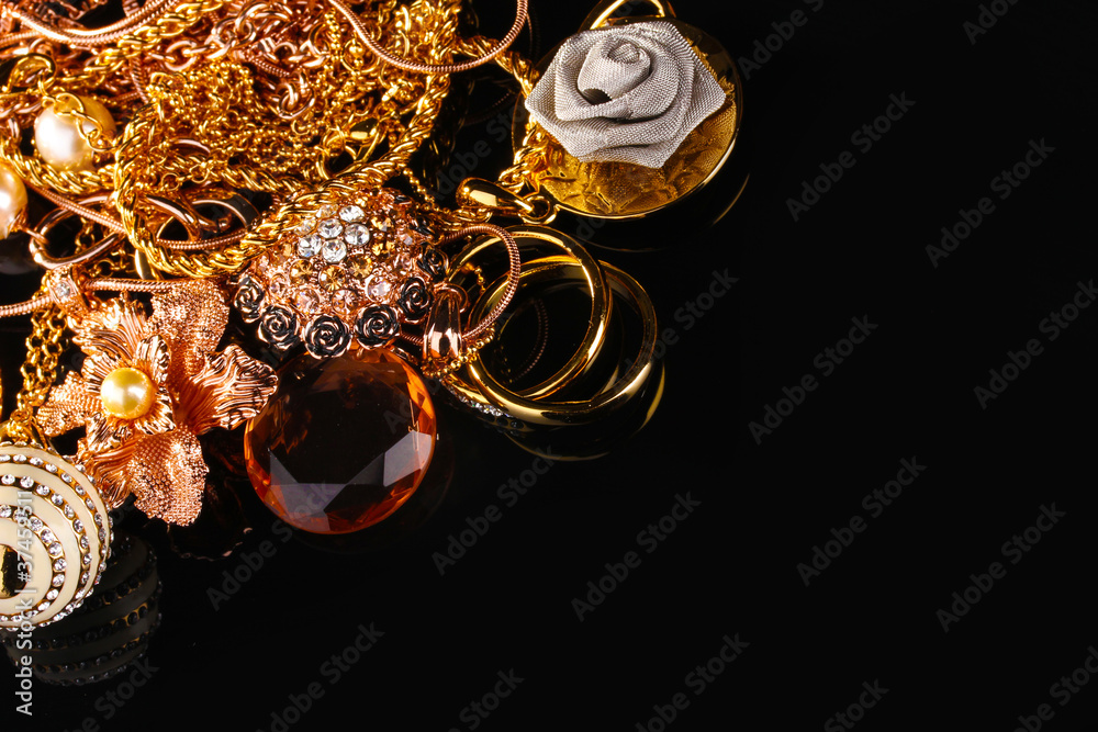 Various gold jewellery on black