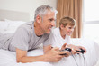 © WavebreakmediaMicro - Happy father and his son playing video games