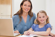 © WavebreakmediaMicro - Beautiful woman helping her daughter doing her homework