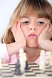 Little girl playing chess