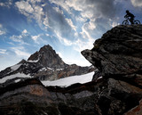 Fototapeta Natura - silhouette of a biker in the Swiss Alps