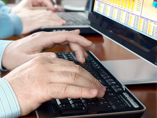Fototapete - Hands typing on computer keyboard