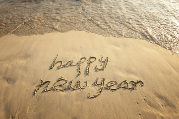 Wall Mural - happy new year written in the sand